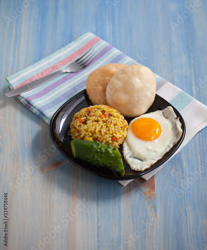 Asian fried rice homemade nasi goreng dish served with prawn crackers krupuk and sunny side up egg