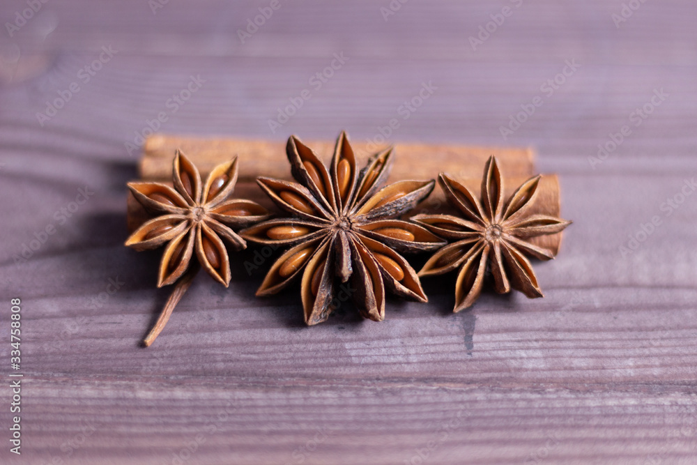 star anise and cinnamon on brown wooden background star anise and cinnamon on brown wooden background