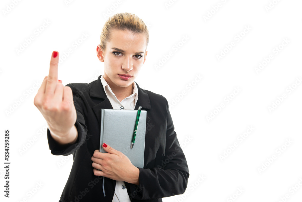 Young female assistant manager holding agenda showing middle finger Young female assistant manager holding agenda showing middle finger