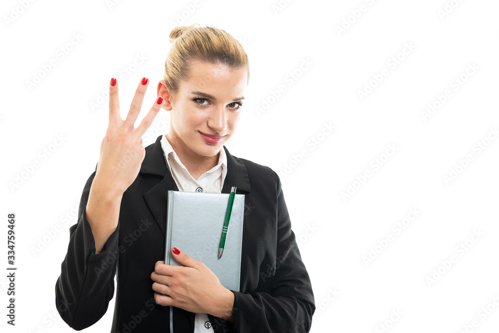 Young female assistant manager holding agenda showing number three Young female assistant manager holding agenda showing number three