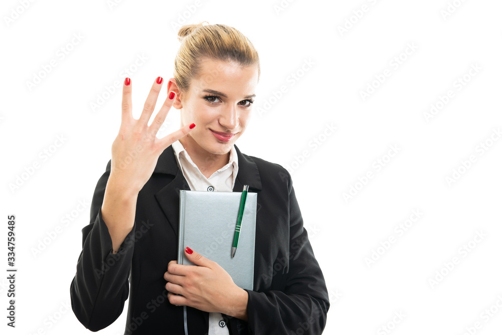 Young female assistant manager holding agenda showing number four Young female assistant manager holding agenda showing number four