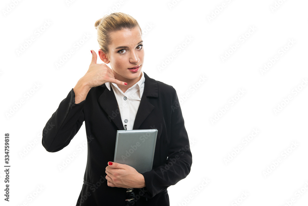 Young female assistant manager holding agenda making calling gesture Young female assistant manager holding agenda making calling gesture