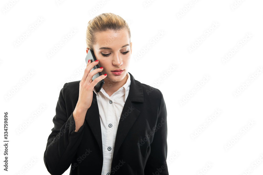Young beautiful female assistant manager talking to smartphone Young beautiful female assistant manager talking to smartphone