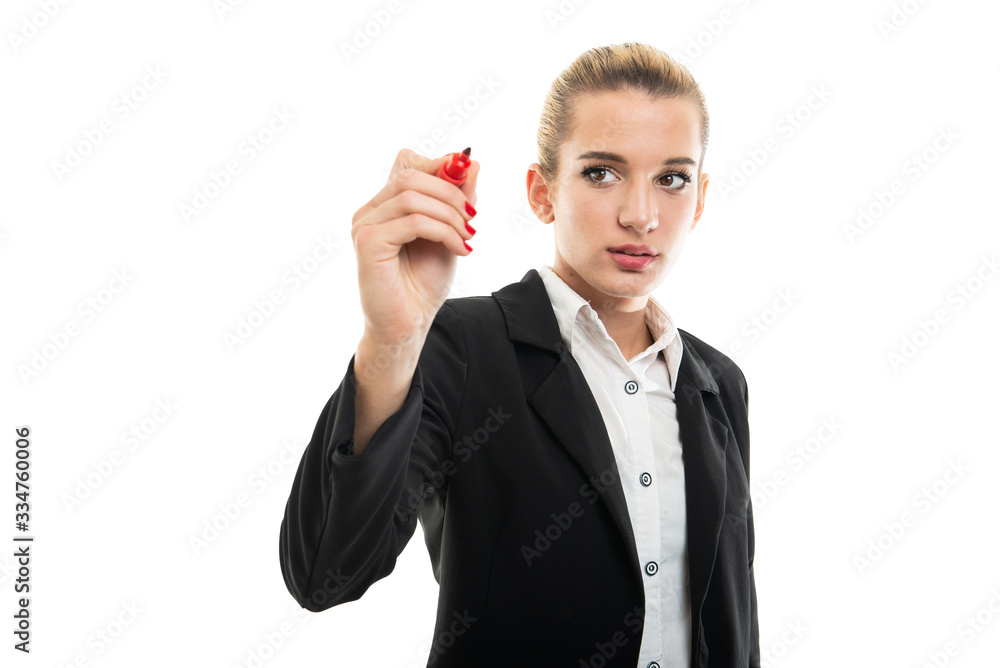 Young female assistant manager writing with red marker Young female assistant manager writing with red marker