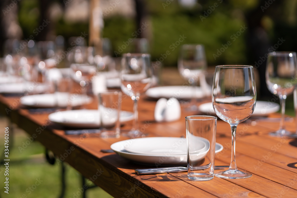 Served wooden table without a tablecloth. Cafe in the open air park Served wooden table without a tablecloth. Cafe in the open air park