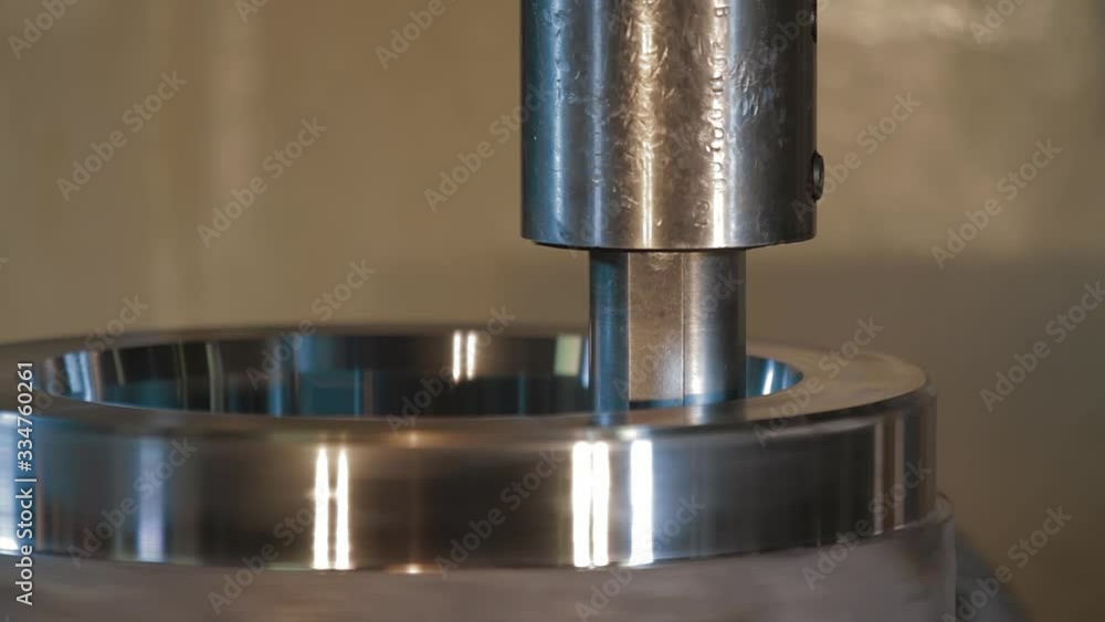 Metalworking milling machine. Produces metal detail in a factory. Machine tools for metal working. A metal workpiece is machined by an electric machine. Cutting metal modern processing technology Metalworking milling machine. Produces metal detail in a factory. Machine tools for metal working. A metal workpiece is machined by an electric machine. Cutting metal modern processing technology