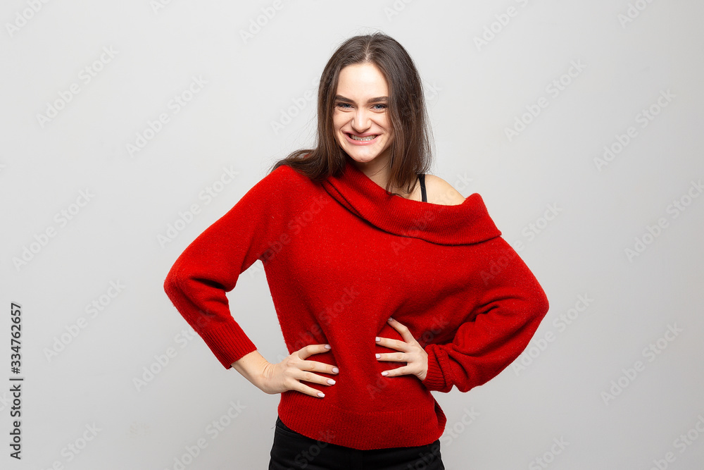 Portrait of a young woman with bright positive emotions on a light gray background. Photo laughs girls. Portrait of a young woman with bright positive emotions on a light gray background. Photo laughs girls.