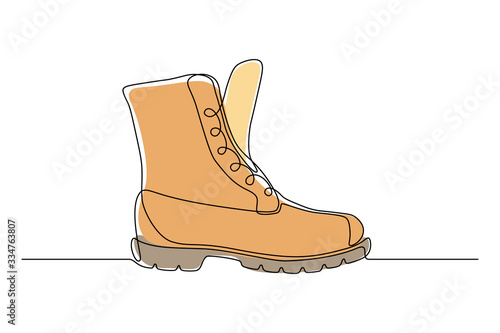 Orange boot in continuous line art drawing style. Weather resistant high shoes isolated on white background. Vector illustration