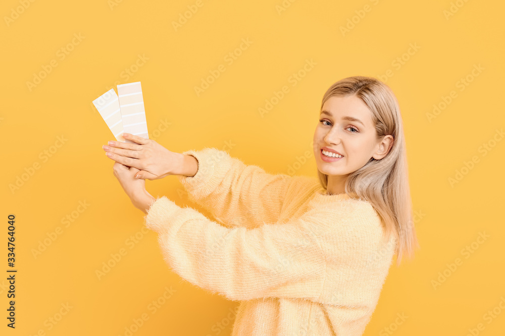 Young woman with paint palette on color background Young woman with paint palette on color background