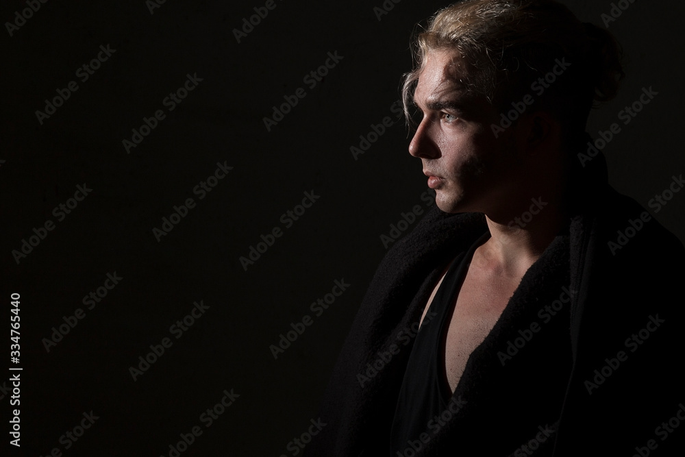 Profile portrait of a blond man on a black background. Beautiful, elegant, advertising Profile portrait of a blond man on a black background. Beautiful, elegant, advertising