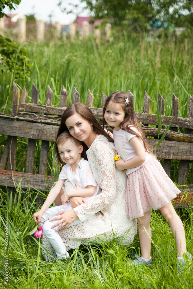 Fototapeta premium Beautiful young woman with kids