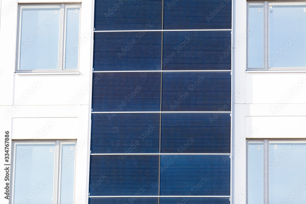 Fototapeta premium White building with Solar panels installed on the outer walls.