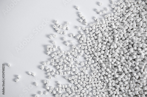 Polypropylene granule close-up background texture. plastic resin ( Masterbatch).Grey chemical granules for industrial plastic production photo