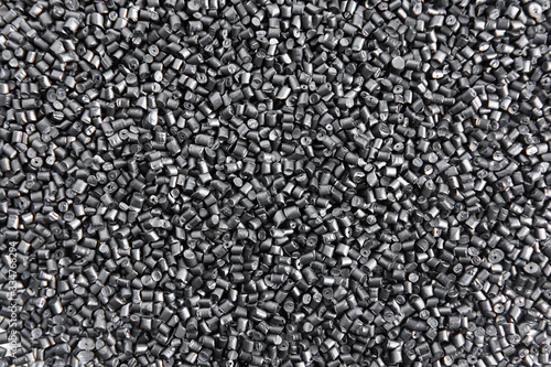 Polypropylene granule close-up background texture. plastic resin ( Masterbatch).Grey chemical granules for industrial plastic production photo