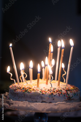 Lit candles on homemade birthday cake