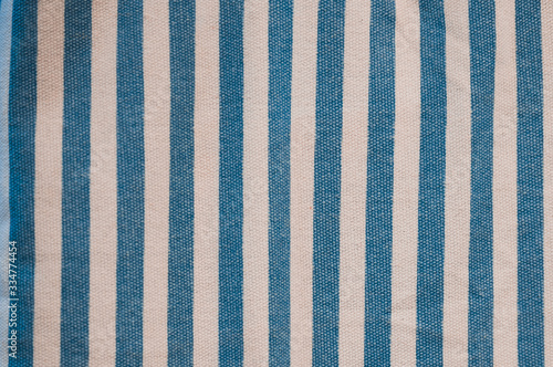 A beautiful and simple blue and white striped fabric made out of wool and cotton with a repeated pattern.