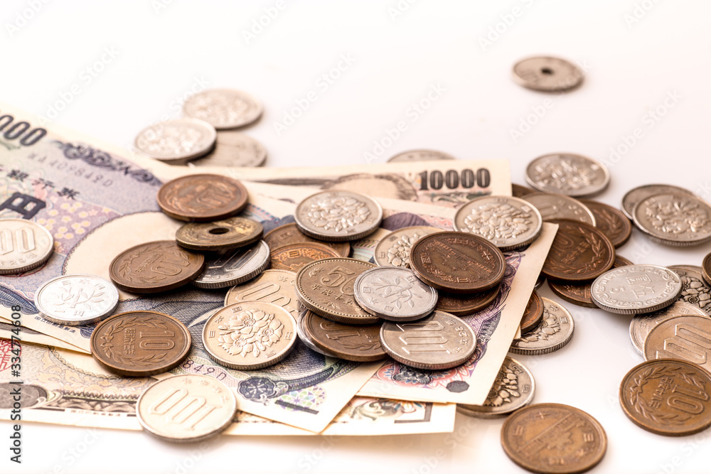 Japanese coins and banknotes and passport on white table Japanese coins and banknotes and passport on white table