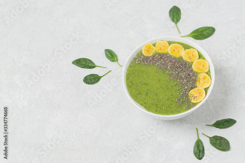 Healthy Breakfast green smoothie bowl with banana, spinach, kiwi and Chia seeds.