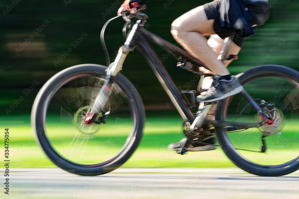 Obraz premium Riding bicycle - blurred motion, fast driving.