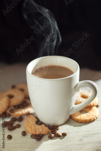 Fototapeta Naklejka Na Ścianę i Meble -  white cup of coffee with milk and cookies and coffee beans