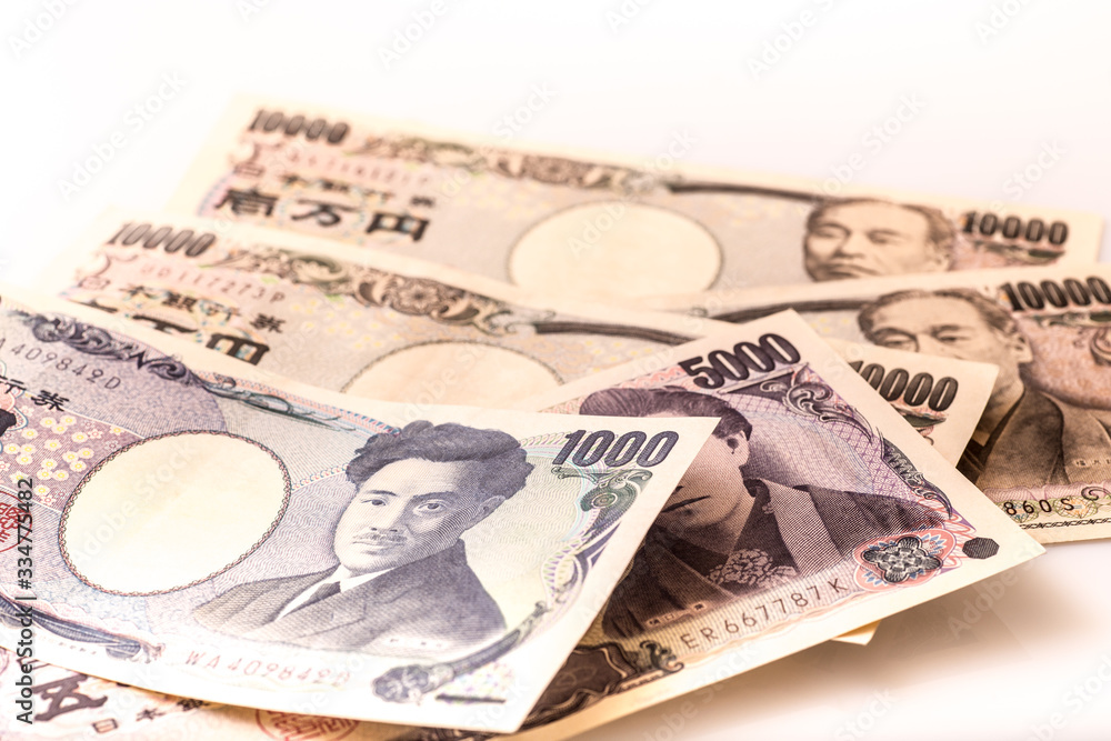 Japanese coins and banknotes and passport on white table Japanese coins and banknotes and passport on white table