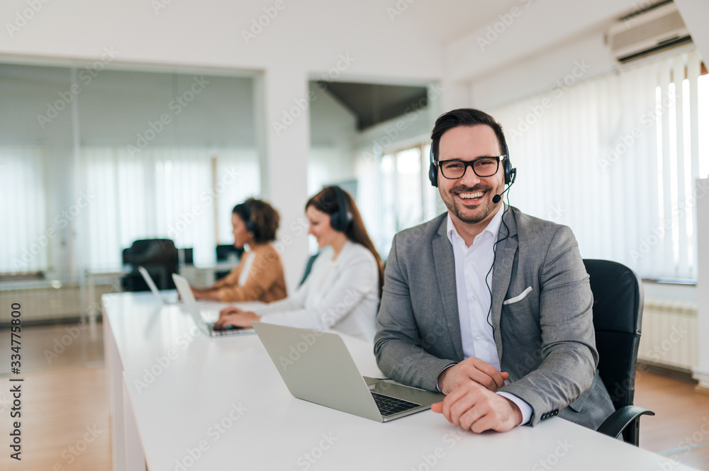 Portrait of a handsome businessman telemarketer at work. Portrait of a handsome businessman telemarketer at work.