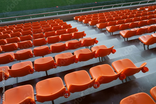 Fotografija Orange spectator seats in a sports stadium