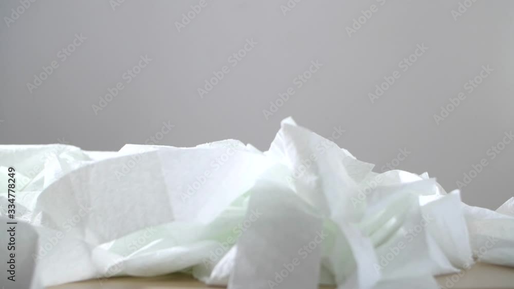 Lot of toilet paper falls on the table. Toilet paper is flying apart. Toilet paper fluttering in the wind. Covidiot. Coronavirus covid-19 shortage concept Lot of toilet paper falls on the table. Toilet paper is flying apart. Toilet paper fluttering in the wind. Covidiot. Coronavirus covid-19 shortage concept