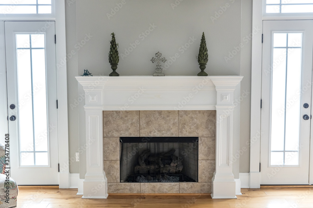 a bright and airy neutral beige living room den in a new construction house with a white and tiled fireplace as the main focal point as well as a decorative rug and lots of natural window light. a bright and airy neutral beige living room den in a new construction house with a white and tiled fireplace as the main focal point as well as a decorative rug and lots of natural window light.