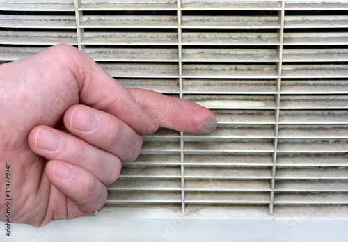 Wallpaper Mural Person checks the contamination of the ventilation grille Torontodigital.ca