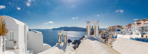 Summer travel and vacation destination landscape. Santorini, panorama of Oia and the Therasia island in the background.