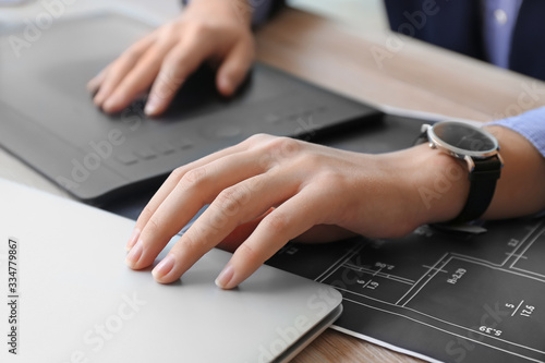 Young female designer worki...