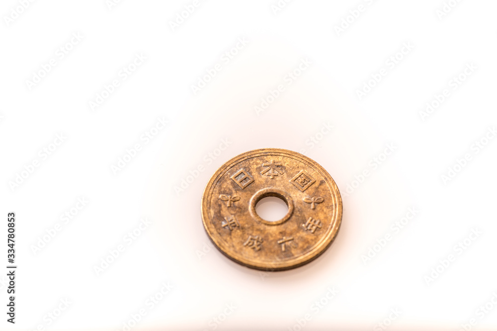 Japanese coins and banknotes and passport on white table Japanese coins and banknotes and passport on white table