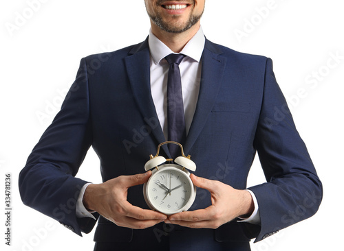 Businessman with alarm cloc...