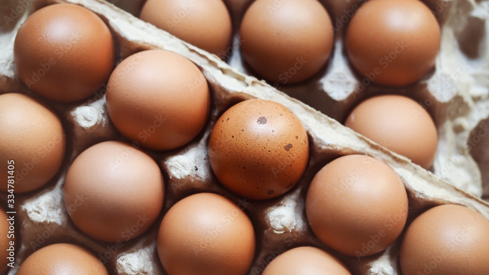 Selective focus, organic brown chicken eggs in carton on rustic wooden table backgrounds for natural healthy food concepts Selective focus, organic brown chicken eggs in carton on rustic wooden table backgrounds for natural healthy food concepts
