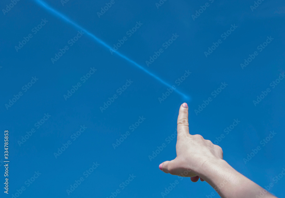 the girl runs her finger across the sky, leaving a white line behind it, a trace the girl runs her finger across the sky, leaving a white line behind it, a trace
