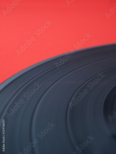 close up look of a vinyl record isolated on red background