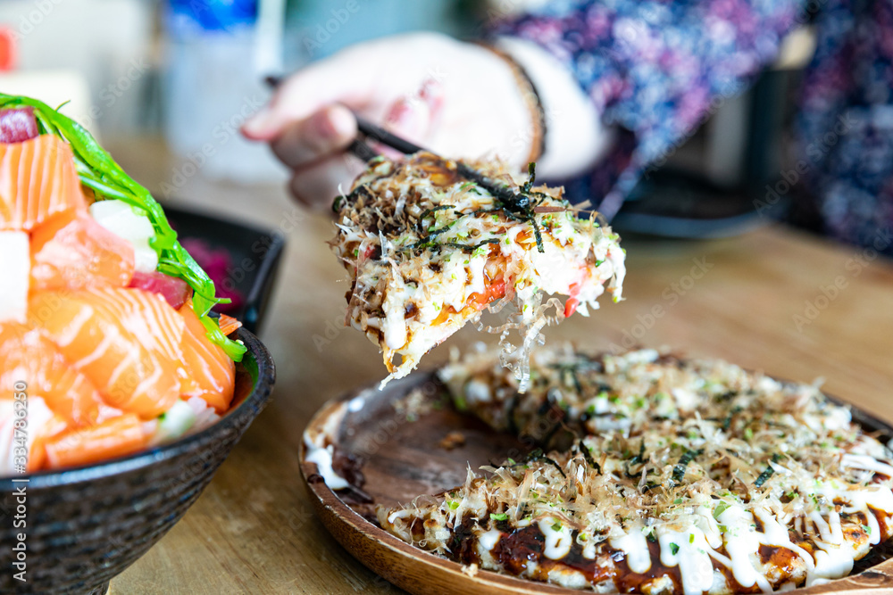 Japanese okonomiyaki or Pizza japan on a table. horizontal top view