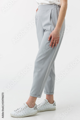 young girl in grey trousers