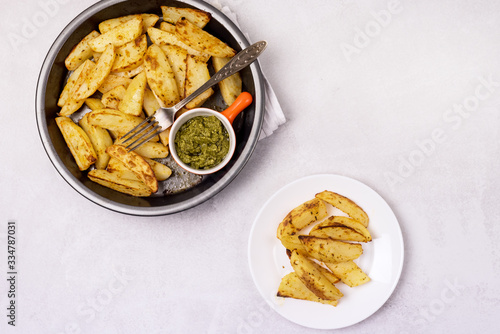 Roasted or Baked Potatoes With Spice in Black Bowl on Light Gray Background Tasty Homemade Dish Dinner Grilled Potatoes Top View Horizontal