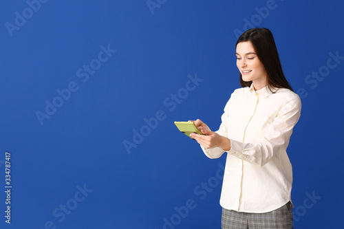 Young woman with calculator...