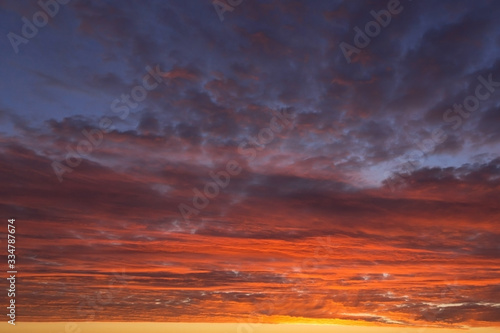 Epic Dramatic bright sunrise, sunset orange yellow pink blue sky with clouds background texture, heaven