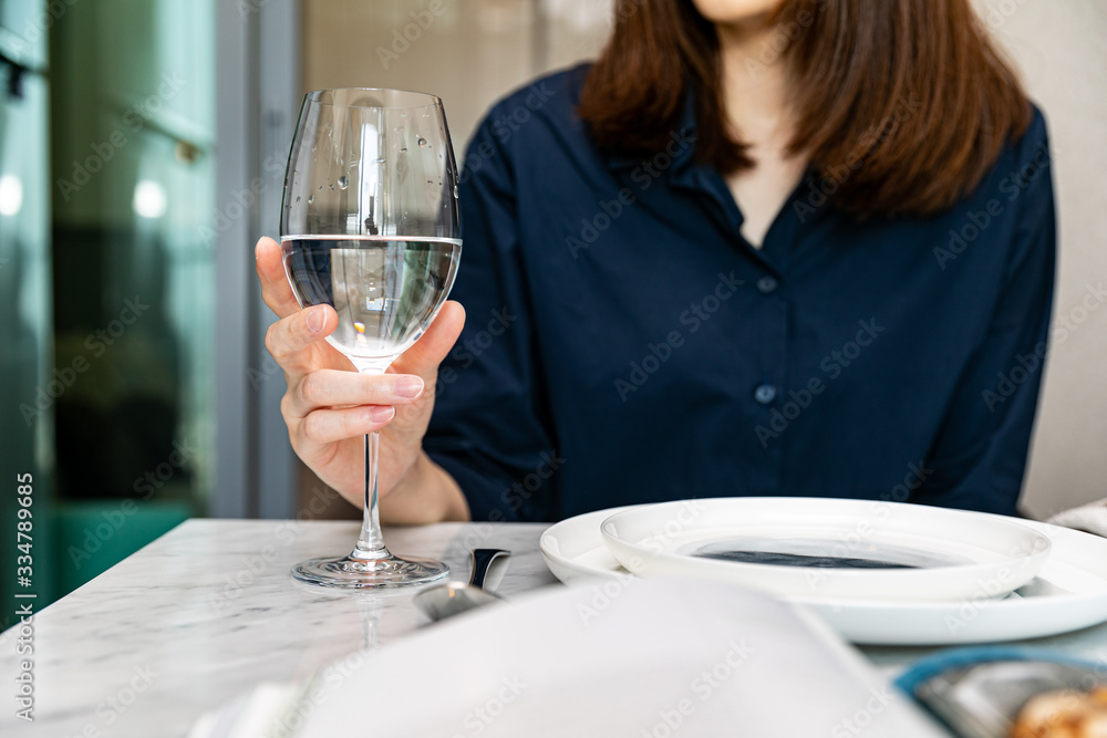 the woman relaxes and drinks a glass of wine