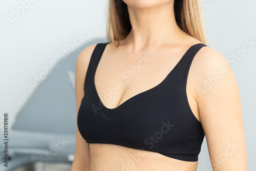 Upper body of a blonde woman in black sporty bra