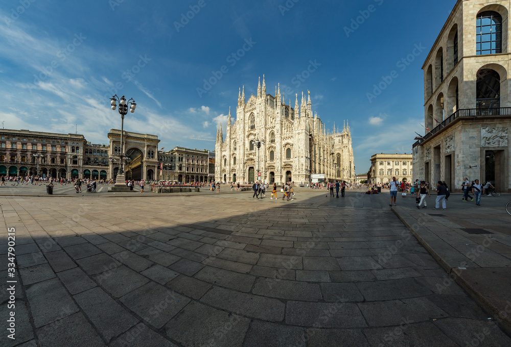 MILAN, ITALY - AUGUST 1, 2019 : The piazza, looking roughly north-east to the Duomo - on the right, and the arch that marks the entrance to Galleria Vittorio Emanuele II - on the left