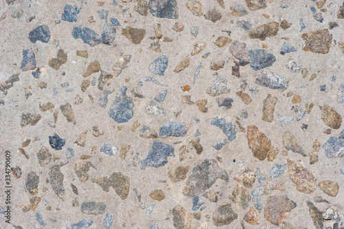 Concrete surface with stones included.