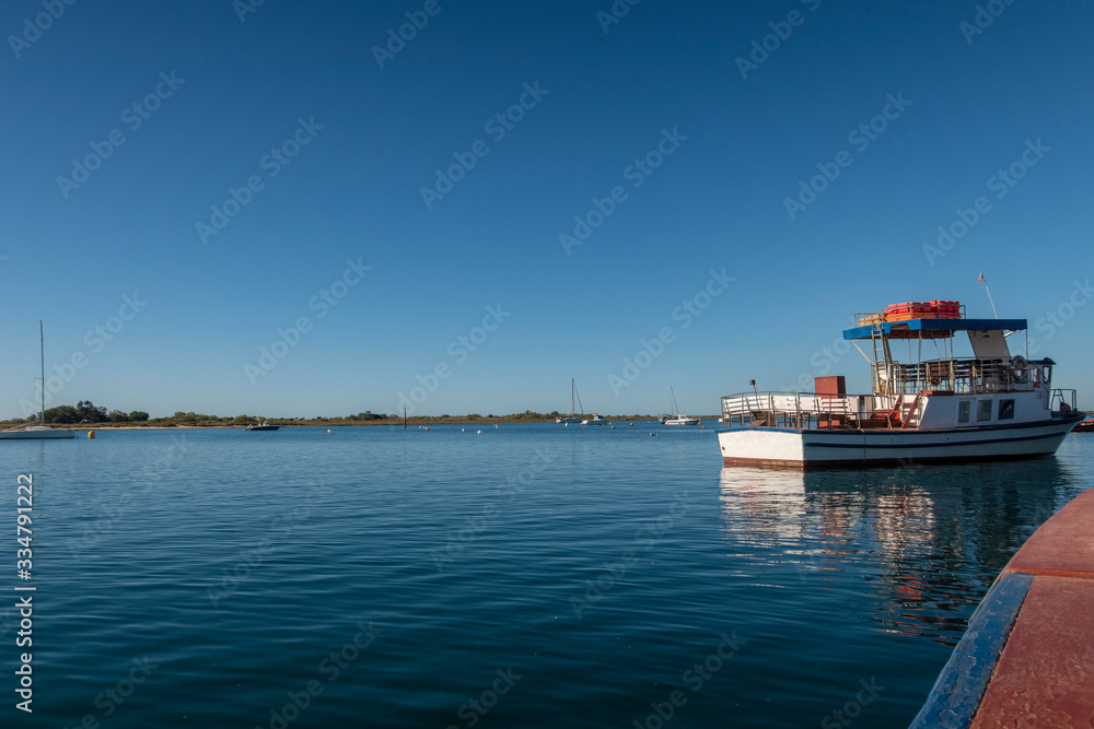 Tourist boat moored on the Gilao River near Tavira, Algarve, Portugal
