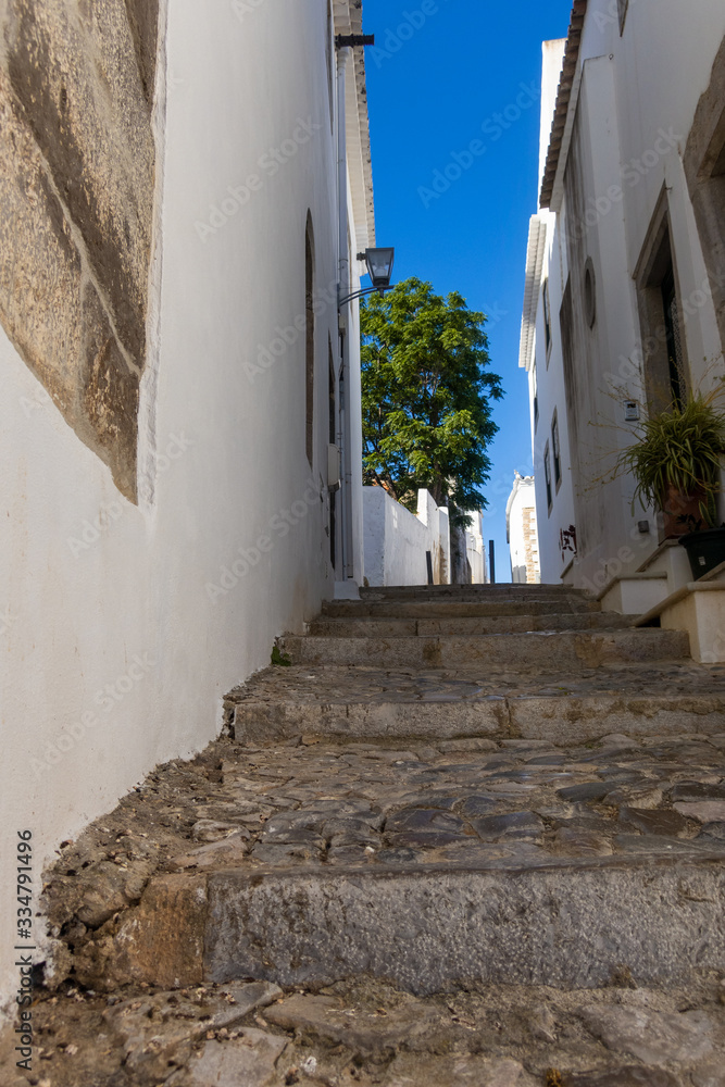 Naklejka premium Narrow cobbled streets of Tavira, Algarve, Portugal
