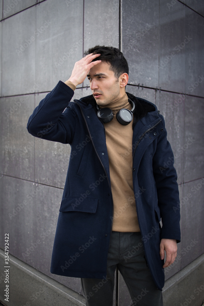 Obraz premium man guy walk headphones coat fashion style city
