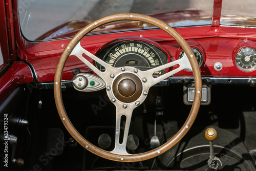 Classic 1951 Simca 8 Sport convertible car looking at dashboard and steering wheel from the drivers seat and top down.